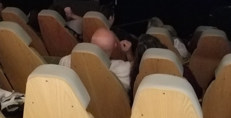 Couple sitting in seats inside planetarium