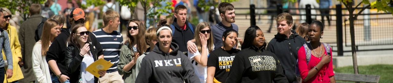 Students walking sunny day on campus  Departments