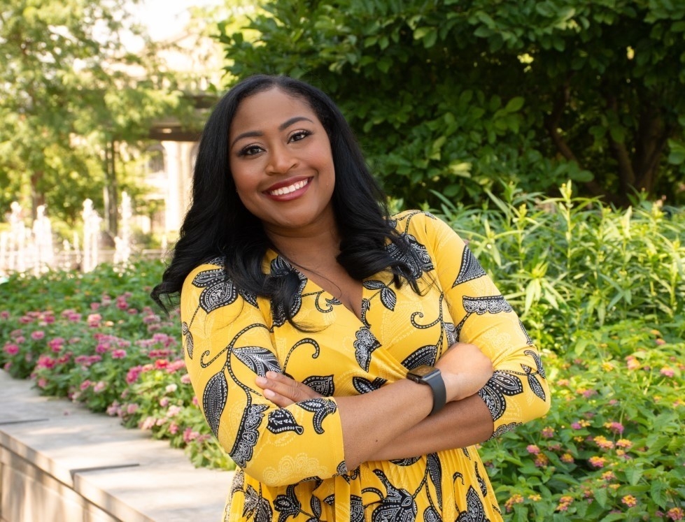 Kamara Douglas in front of flowers
