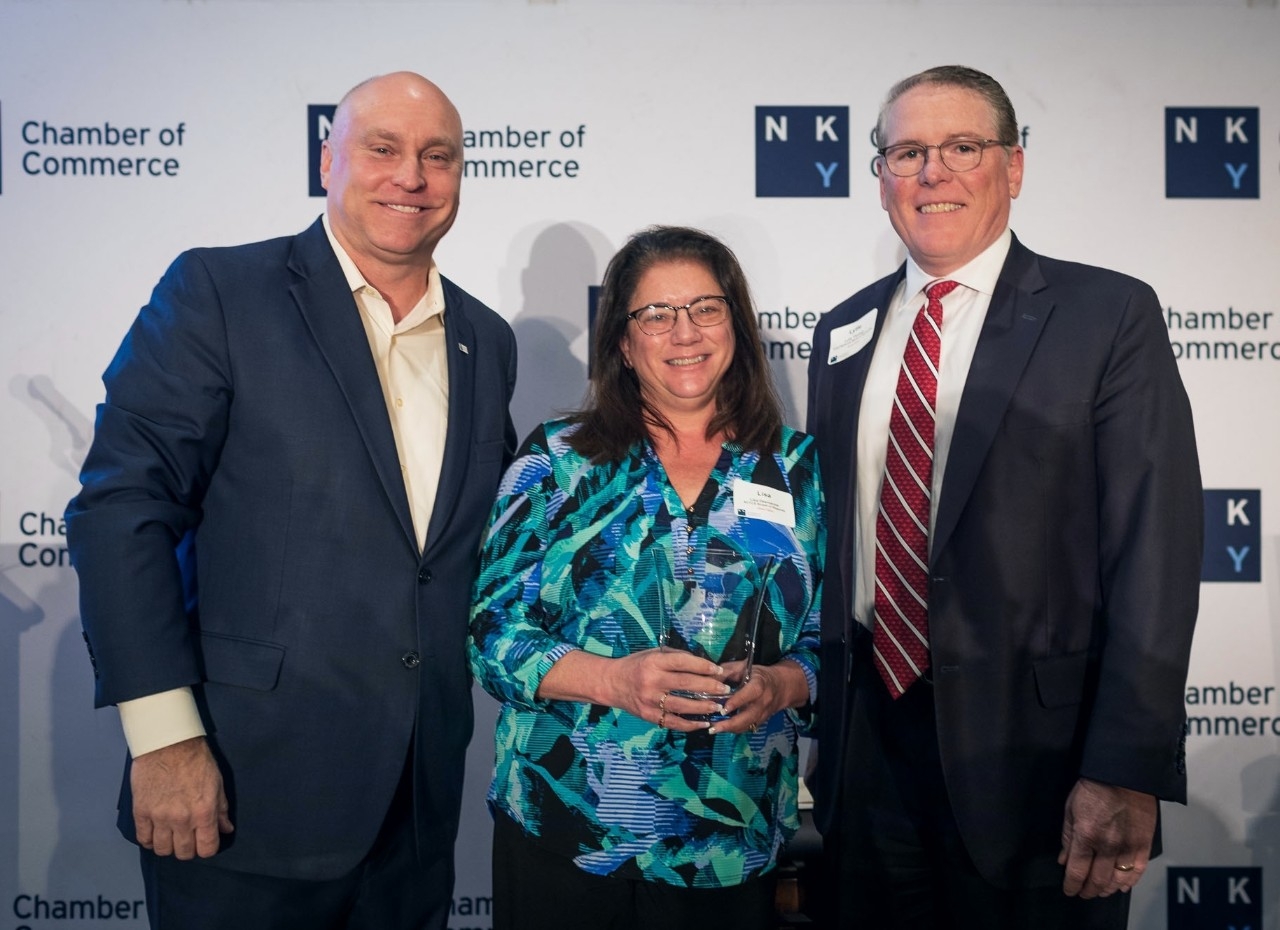 Lisa Desmairis in between two chamber of commerce presenters