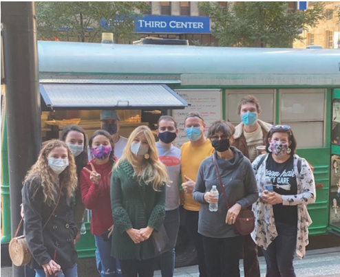 Group of students standing next to a food truck