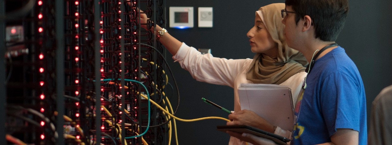 Two students looking at a server rack