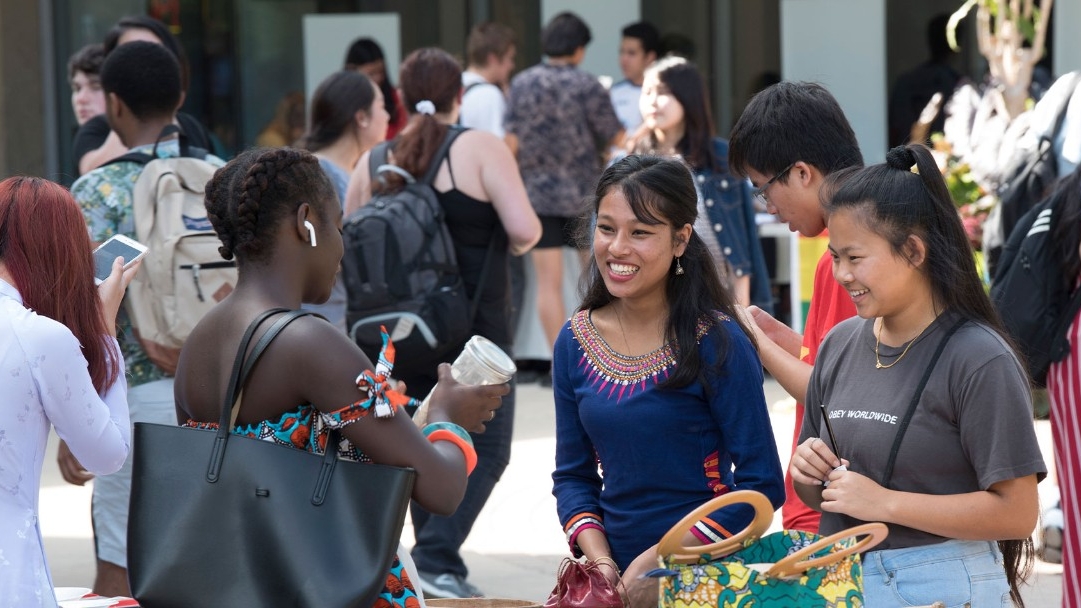 International students in a group talking at an event