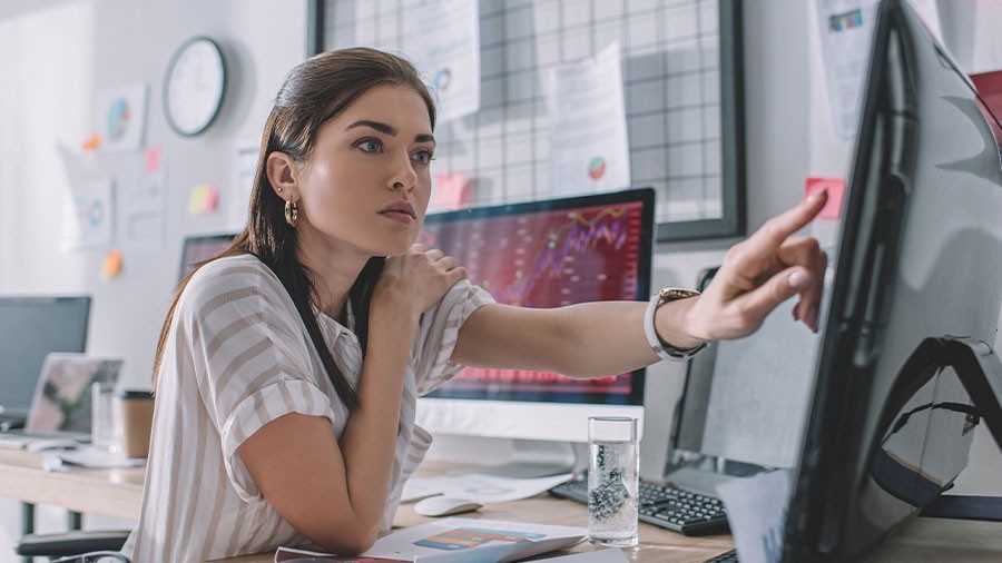 A woman examines data on a computer screen