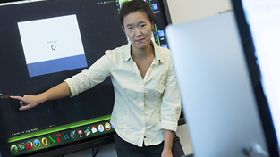 Woman speaking in front of class giving instruction