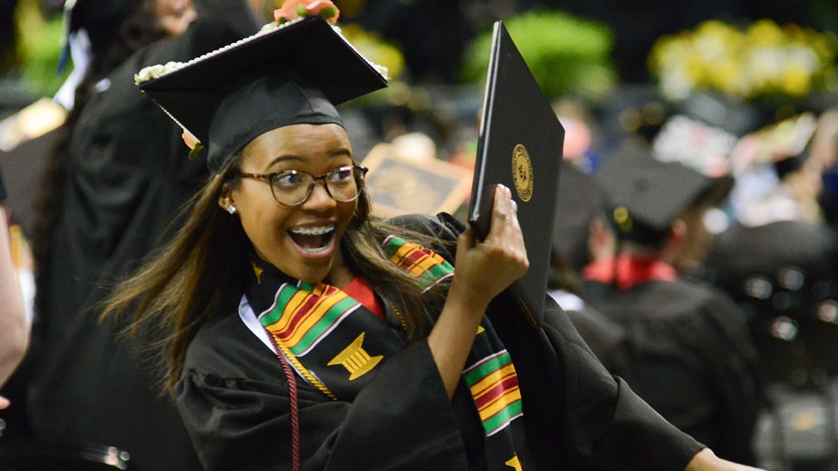 Student wearing cap and gown at commencement